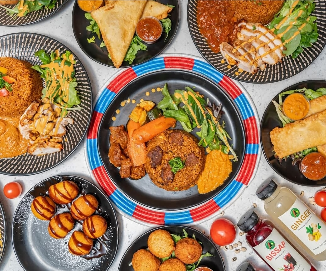 Full Senegalese feast spread with Thieboudienne, Fataya, grilled chicken and Bissap