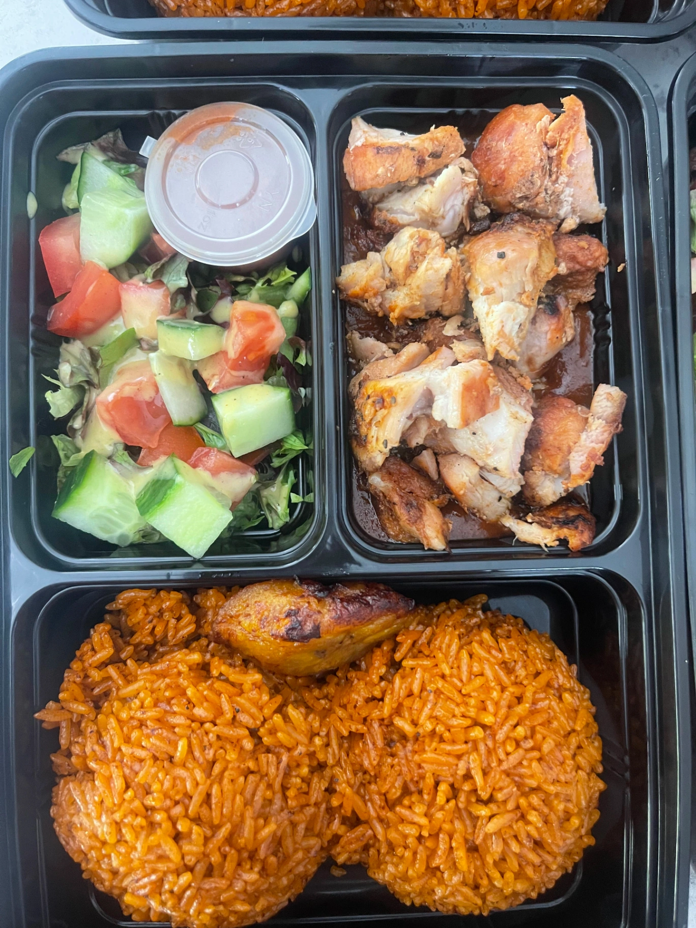 Jollof bento with chicken and salad